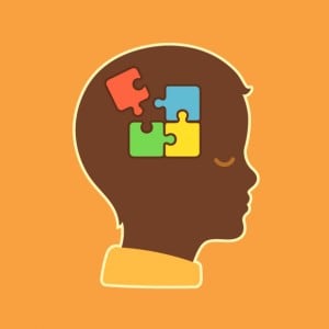 child head profile silhouette with jigsaw puzzle symbolizing autism spectrum disorders